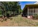 Side view of a home with a screened porch at 3800 Acline Rd, Punta Gorda, FL 33950