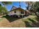 White house with mature trees and grassy lawn at 3800 Acline Rd, Punta Gorda, FL 33950