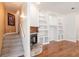 Living room with hardwood floors, built-in shelving, and a stone fireplace at 3800 Acline Rd, Punta Gorda, FL 33950