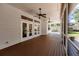 Spacious screened porch with wood deck, ceiling fans and access to the backyard at 3800 Acline Rd, Punta Gorda, FL 33950