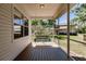 Screened porch with wood deck, ceiling fan and a swing overlooking the backyard at 3800 Acline Rd, Punta Gorda, FL 33950