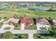 Aerial view of homes with lush landscaping, golf course, and scenic lakes at 3818 Bordeaux Dr, Punta Gorda, FL 33950