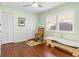Bright bedroom with hardwood floors, ceiling fan, and a large window at 3818 Bordeaux Dr, Punta Gorda, FL 33950