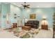 Stylish living room with high ceilings, and comfortable seating on a tropical patterned rug at 3818 Bordeaux Dr, Punta Gorda, FL 33950