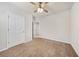 Spacious bedroom with ceiling fan and carpet at 5445 Shell Mound Cir, Punta Gorda, FL 33982