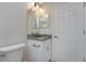 Clean bathroom with a toilet, vanity, and a mirror at 5587 E Price Blvd, North Port, FL 34288