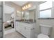 Bright bathroom with double vanity, granite countertop, window, and view into the bedroom at 5587 E Price Blvd, North Port, FL 34288
