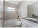 Bathroom with a tub, white vanity, and granite countertop at 5587 E Price Blvd, North Port, FL 34288