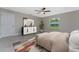 Bedroom with ceiling fan, window views, and a modern dresser with storage at 5587 E Price Blvd, North Port, FL 34288