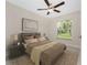 Comfortable bedroom with a ceiling fan, large window, and stylish decor at 5587 E Price Blvd, North Port, FL 34288
