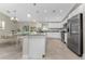 Bright kitchen with stainless appliances, island seating, and pendant lighting at 5587 E Price Blvd, North Port, FL 34288