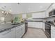 Bright kitchen features granite countertops, white cabinets and stainless steel appliances at 5587 E Price Blvd, North Port, FL 34288