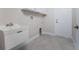 Bright laundry room includes a utility sink and exterior access at 5587 E Price Blvd, North Port, FL 34288
