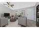 Bright living room features a ceiling fan, neutral color palette, and elegant furnishings at 5587 E Price Blvd, North Port, FL 34288
