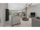Bright living room with ceiling fan and open floor plan to kitchen and dining at 5587 E Price Blvd, North Port, FL 34288