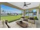 Relax on the screened patio with outdoor seating and lush backyard views at 5587 E Price Blvd, North Port, FL 34288
