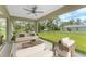 Inviting screened-in patio offers comfortable seating and views of the green backyard at 5587 E Price Blvd, North Port, FL 34288