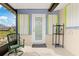 Back patio with storage and a door leading inside at 817 E 6Th St, Englewood, FL 34223