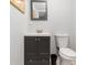 Small bathroom with dark vanity and white toilet at 817 E 6Th St, Englewood, FL 34223