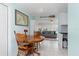 Small dining area with wooden table and chairs, view into living room at 817 E 6Th St, Englewood, FL 34223