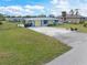 Bright yellow and blue house with a spacious front yard at 817 E 6Th St, Englewood, FL 34223