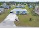 Cute yellow and blue house with nicely landscaped front yard at 817 E 6Th St, Englewood, FL 34223