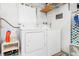 Laundry room with washer, dryer, and storage shelves at 817 E 6Th St, Englewood, FL 34223