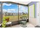 Relaxing screened porch with outdoor seating and backyard view at 817 E 6Th St, Englewood, FL 34223