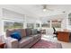 Sunroom with grey couch, wooden desk, and view of backyard at 817 E 6Th St, Englewood, FL 34223