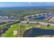 Aerial view of community featuring golf course, lake, and luxury homes at 14070 Heritage Landing Blvd # 423, Punta Gorda, FL 33955