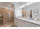 Elegant bathroom with double vanity, granite countertop, and large shower at 14070 Heritage Landing Blvd # 423, Punta Gorda, FL 33955