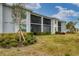 Ground level view of building exterior with lush landscaping at 14070 Heritage Landing Blvd # 423, Punta Gorda, FL 33955