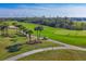 Aerial view of a lush golf course with palm trees and players at 14070 Heritage Landing Blvd # 423, Punta Gorda, FL 33955