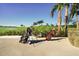 Golf bags sit by a beautiful golf course with palm trees and a clear blue sky at 14070 Heritage Landing Blvd # 423, Punta Gorda, FL 33955