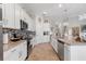 Bright kitchen featuring granite countertops and white cabinetry at 14070 Heritage Landing Blvd # 423, Punta Gorda, FL 33955