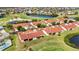 Stunning aerial view of a townhome community with a golf course, lake, and well-maintained landscaping at 1640 Atares Dr # 6, Punta Gorda, FL 33950