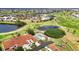 An aerial view features a community with several ponds and a golf course at 1640 Atares Dr # 6, Punta Gorda, FL 33950