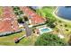 An aerial view features a community with a swimming pool, lake, and golf course at 1640 Atares Dr # 6, Punta Gorda, FL 33950