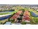 Expansive aerial view of a townhome community surrounded by a golf course, lakes, and meticulously maintained grounds at 1640 Atares Dr # 6, Punta Gorda, FL 33950