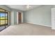 Bedroom with sliding glass door has green walls, ceiling fan, and closet at 1640 Atares Dr # 6, Punta Gorda, FL 33950