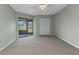 Neutral bedroom featuring a ceiling fan, closet, and glass sliding doors at 1640 Atares Dr # 6, Punta Gorda, FL 33950