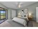 Cozy bedroom with large bed, ceiling fan, neutral tones, and a sliding glass door to a balcony at 1640 Atares Dr # 6, Punta Gorda, FL 33950