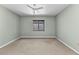 This bedroom features neutral carpeting and one window providing natural light at 1640 Atares Dr # 6, Punta Gorda, FL 33950