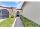 A view of the entrance and landscaped walkway with greenery, leading to a charming residence at 1640 Atares Dr # 6, Punta Gorda, FL 33950