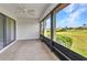 Enclosed lanai with a ceiling fan, carpet floors, and view of the lush lawn and blue skies at 1640 Atares Dr # 6, Punta Gorda, FL 33950