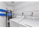 This laundry room features a washer, dryer, water heater, and shelving for storage at 1640 Atares Dr # 6, Punta Gorda, FL 33950