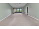 Spacious living room with neutral paint, plush carpeting, and sliding glass doors to the outside at 1640 Atares Dr # 6, Punta Gorda, FL 33950