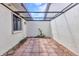 Enclosed patio with red brick flooring and black metal lattice covering at 1640 Atares Dr # 6, Punta Gorda, FL 33950