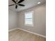 Well-lit bedroom with wood-look floors and window shutters at 180 W Pine Valley Ln, Rotonda West, FL 33947