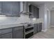 Modern kitchen with stainless steel appliances and white subway tile backsplash at 180 W Pine Valley Ln, Rotonda West, FL 33947